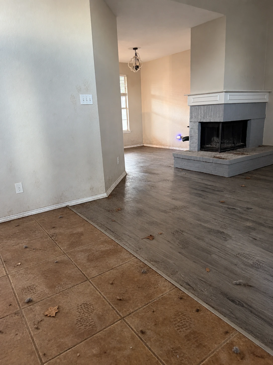 Empty home with dirty floors before move-out cleaning